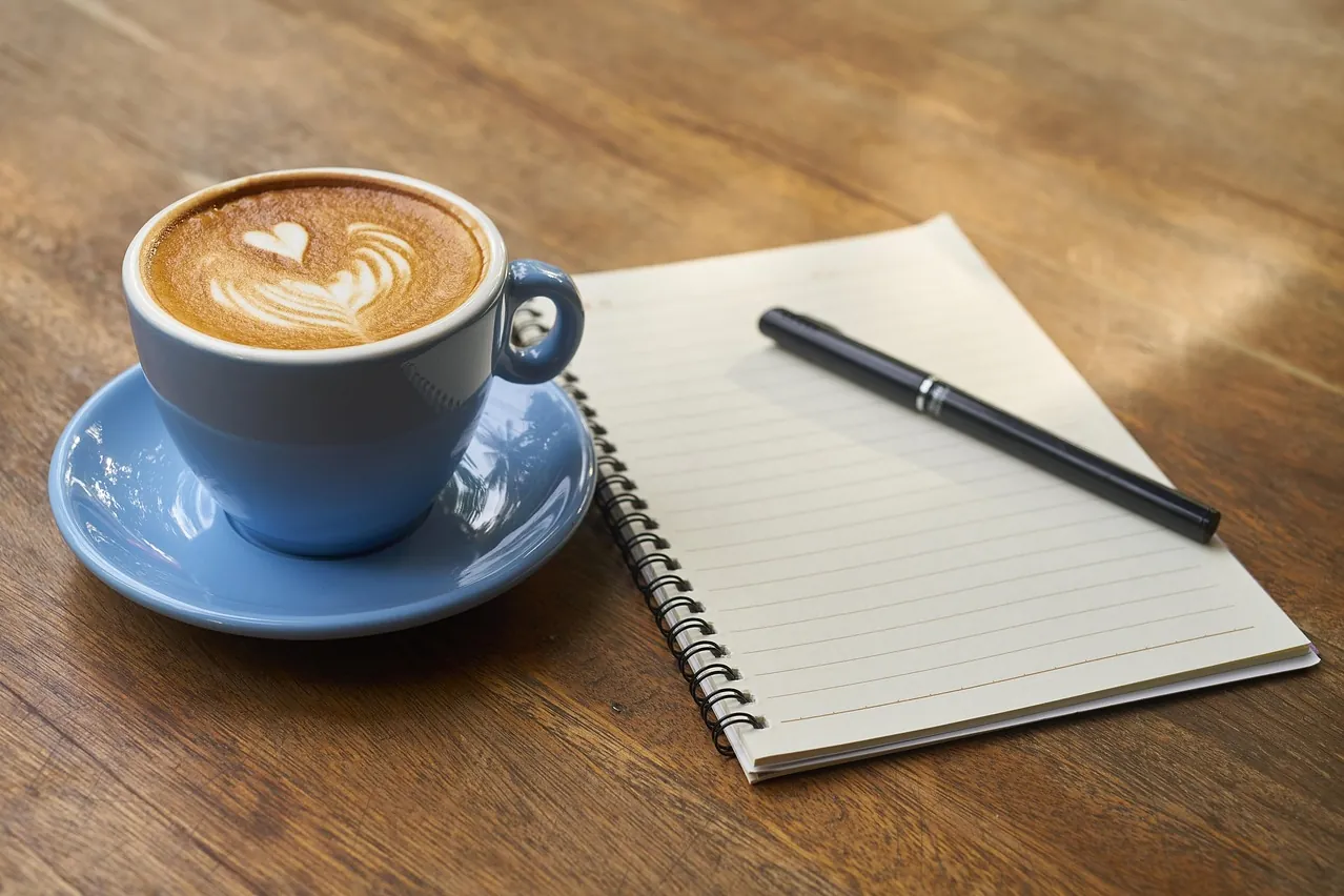Coffee, pen, notebook