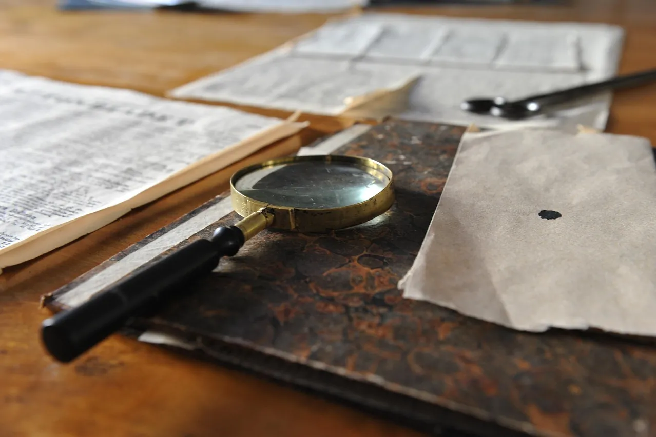 Magnifying glass, sheet, writing desk